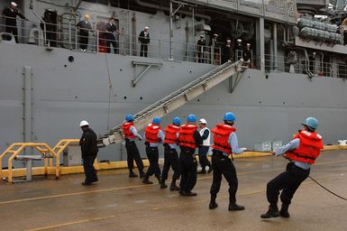 U.S. Navy line handlers from the Harpers Ferry Class Dock Landing Ship USS OAK HILL (LSD 51) assist in raising the brow of the Whidbey Island Class Ship USS ASHLAND (LSD 48) as she prepares to deploy on November 16, 2006. The ASHLAND will relieve Tarawa Class Amphibious Assault Ship USS SAIPAN (LHA 2) in the 5th Fleet area of responsibility. (U.S. Navy photo by Mass Communication SPECIALIST Second Class (AW/SW) Pamela Coxe) (Released)