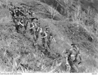 RAMU VALLEY AREA, NEW GUINEA. 1943-11-08. TROOPS OF THE 2/27TH AUSTRALIAN INFANTRY BATTALION MOVING ALONG THE TRACK FROM GUY'S POST. SHOWN ARE: SX4606 WARRANT OFFICER I. LYNDON (1); SX9812 PRIVATE ..