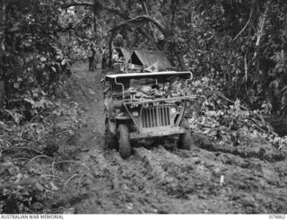 WAITAVALO AREA, WIDE BAY, NEW BRITAIN. 1945-03-16. A JEEP AMBULANCE ASSISTING TO EVACUATE WOUNDED PERSONNEL OF THE 14/32ND INFANTRY BATTALION FROM THE DRESSING STATION OF THE 6TH FIELD AMBULANCE, ..