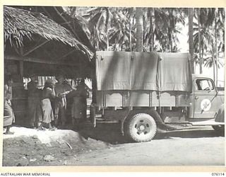 MILILAT, NEW GUINEA. 1944-09-21. RED CROSS SUPPLIES BEING LOADED INTO A TRUCK AT THE BULK STORE OF THE AUSTRALIAN RED CROSS SOCIETY ATTACHED TO HEADQUARTERS 5TH DIVISION. THE SUPPLIES WILL BE ..