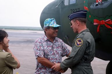 The governor of Saipan thanks Brig. GEN. Michael McCarthy, commander of the 374th Airlift Wing, for his unit's participation in Christmas Drop '92. On the 40th anniversary of the humanitarian effort, personnel and aircraft from the wing delivered gifts to islanders of the Federated States of Micronesia. Every year since 1952, food, clothing, tools and toys donated by residents of Guam have been delivered by air to 40 Micronesian islands