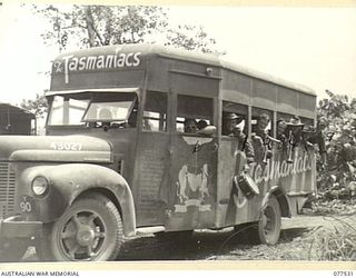 BOUGAINVILLE ISLAND. 1944-12-07. MEMBERS OF THE "TASMANIACS" - THE TASMANIA LINES OF COMMUNICATION CONERT PARTY SETTING OUT FOR AN OUTLYING AUSTRALIAN SERVICE UNIT IN THEIR SPECIAL MOTOR VEHICLE. ..