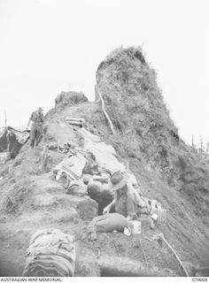 SHAGGY RIDGE, NEW GUINEA. 1944-01-10. THE TIP OF THE "PIMPLE" ON SHAGGY RIDGE. ON THE LEFT IS THE COMMAND POST OF "A" COMPANY 2/9TH INFANTRY BATTALION. QX6030 MAJOR F.E.C. LOXTON (1). NX97235 ..