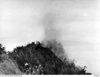 Finisterre Range, New Guinea. 22 March 1944. Smoke rises after the strafing of Japanese positions on the Pimple during the final assault on Shaggy Ridge. A shot from the Department of Information ..