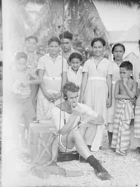 [Group of Pacific Island children watch radio operator]