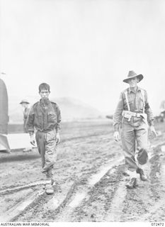 DUMPU, NEW GUINEA. 1944-04-19. CORPORAL T.W. BELL, A MEMBER OF THE 11TH DIVISION PROVOST COMPANY (1), ESCORTING A JAPANESE PRISONER OF WAR CAPTURED AT NAP NAP ON THE WANTOAT RIVER TO HEADQUARTERS ..