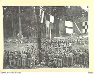 MANGUNUI, JACQUINOT BAY, NEW BRITAIN. 1945-02-25. AUSTRALIAN TROOPS WATCHING NATIVES AT PRACTICE BEFORE THE COMMENCEMENT OF A NATIVE SING- SING AT THE AUSTRALIAN NEW GUINEA ADMINISTRATIVE UNIT ..