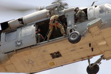 Royal Australian Navy (RAN) Sailors and US Navy (USN) Sailors aboard a USN MH-60S Sea Hawk helicopter form Helicopter Sea Combat Squadron 25 (HSC-25) conduct rappel training during a Helicopter Rope Suspension Technique (HRST) training exercise held at Polaris Point, Santa Rita Naval Base, Guam (GU), during the Annual Multi-national Explosive Ordnance Disposal (EOD) Exercise known as TRICARB 2006." The Exercise brings together EOD Units from the US, Australia and Singapore