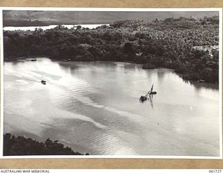 FINSCHHAFEN, NEW GUINEA. 1943-12-05. AERIAL VIEW OF A BOMB DAMAGED WRECK IN THE HARBOUR