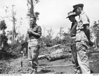 MOEM, WEWAK AREA, NEW GUINEA, 1945-09-17. THE REBURIAL SERVICE, CONDUCTED BY CHAPLAIN S. COWEN, HQ 6 DIVISION (1), AT THE AIF WAR CEMETERY, FOR THREE AUSTRALIAN SOLDIERS OF THE Z SPECIAL FORCE ..