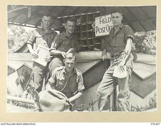 LAE, NEW GUINEA. 1944-10-03. POSTAL UNIT AND STAFF AT HEADQUARTERS 6TH INFANTRY BRIGADE. IDENTIFIED PERSONNEL ARE:- VX115711 CORPORAL T. ROOT (1); VX123880 SERGEANT L.F. HALFPENNY (2); VX120492 ..