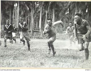 SOUTH ALEXISHAFEN, NEW GUINEA. 1944-09-10. AN EXCITING MOMENT DURING THE RUGBY LEAGUE MATCH BETWEEN TEAMS FROM THE 61ST INFANTRY BATTALION "THE QUEENSLAND CAMERON HIGHLANDERS" AND THE 30TH INFANTRY ..