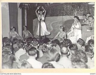 LAE AREA, NEW GUINEA, 1945-07-09. THE HULA DANCE SCENE DURING THE REVUE "OVER TO YOU", STAGED BY 19 LINES OF COMMUNICATION AREA SIGNALS IN THE UNIT'S RECREATION HUT, WHICH WAS KNOWN FOR THE EVENING ..