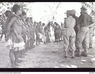 KOIL ISLAND, NEW GUINEA, 1945-10-31. A VISIT TO KOIL ISLAND WAS ARRANGED BY THE RED CROSS FOR THE PURPOSE OF MEDICAL INSPECTION OF THE NATIVE INHABITANTS. THE VISITING PARTY CONSISTED OF AN ..