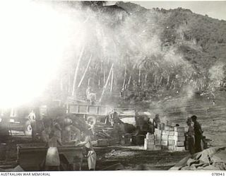 KIEP, NEW BRITAIN. 1945-02-07. TROOPS OF HEADQUARTERS, 6TH INFANTRY BRIGADE LOADING STORES ON TO TRUCKS AT THE WIDE BAY BEACHHEAD