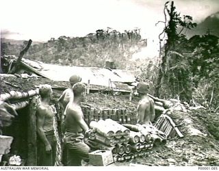THE SOLOMON ISLANDS, 1945-03-27. AUSTRALIAN MORTAR CREW WATCHING THE RESULT OF THEIR SHOOTING NEAR THE NUMA NUMA TRAIL ON BOUGAINVILLE ISLAND. (RNZAF OFFICIAL PHOTOGRAPH.) (SAME PHOTOGRAPH AS ..