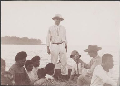 Bishop Wilson and others on boat returning to the Southern Cross from Ulawa, Solomon Islands, 1906 / J.W. Beattie