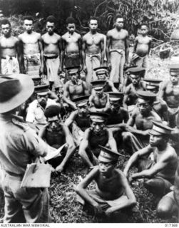 Karkar Island, New Guinea. 1944-05. An Australian New Guinea Administrative officer addressing village chiefs on Karkar Island after the Allied occupation. He is telling them about the Allied ..