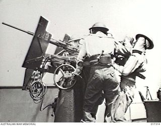 AT SEA, NEW GUINEA. 1944-06-19. MANNING THE ANTI-AIRCRAFT GUN ON THE AUSTRALIAN BUILT TRIBAL CLASS DESTROYER "ARUNTA" DURING OPERATIONS IN NORTHERN WATERS IN THE HOLLANDIA ACTION