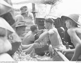 NAGADA, NEW GUINEA. 1944-08-16. GUNNERS OF E TROOP, 22ND BATTERY, 106TH TANK ATTACK REGIMENT, OPERATING A 6 POUNDER TANK ATTACK GUN DURING A PRACTICE SHOOT. IDENTIFIED PERSONNEL ARE:- VX70936 ..