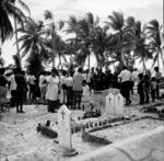 Mourners assembled at the burial ground around the grave