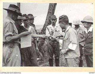 KAHILI, BOUGAINVILLE. 1945-10-01. HIGH RANKING JAPANESE ARMY AND NAVAL OFFICERS ON BOUGAINVILLE WERE ESCORTED IN THEIR OWN BARGES FROM KAHILI FOR CONCENTRATION ON SAMANSO ISLAND. SHOWN, JAPANESE ..