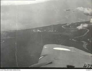 AIRBORNE NEAR LINDENHAFEN, NEW BRITAIN. 1944-01-17. BEAUFORT BOMBER AIRCRAFT OF NOS. 6, 8 AND 100 SQUADRONS RAAF TOOK PART IN A MASSED DAYLIGHT RAID ON AN ENEMY CAMP AND DUMP AREA ON THE AMGEN ..