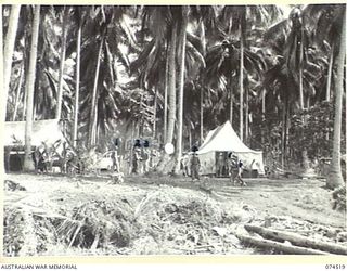 MATUPI, NEW GUINEA. 1944-07-04. A SECTION OF THE CAMP AREA OF THE 15TH FIELD AMBULANCE. THE TENT ON THE LEFT IS THE ORDERLY ROOM, THE TENT IN THE CENTRE IS THE REGIMENTAL AID POST, WHILE THE ..