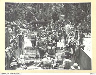 SIO MISSION, NEW GUINEA. 1944-01-24. "D" COMPANY, 4TH INFANTRY BATTALION, EMBARKING AT THE LANDING BEACH NEAR SIO MISSION ON A LANDING CRAFT MECHANIZED. IDENTIFIED PERSONNEL ARE: T102296 PRIVATE ..