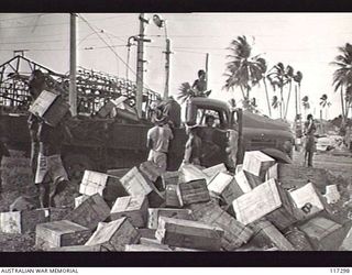 NAURU ISLAND. 1945-09-16. NAURUANS UNLOADING SUPPLIES FROM TRUCKS AT THE CAMP OF THE 31/51ST INFANTRY BATTALION SOON AFTER THE UNIT HAD TAKEN OVER THE ISLAND FROM THE JAPANESE