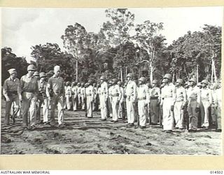 1943-03-25. NEW GUINEA. BRIG. GENERAL JOHNS (RIGHT) AND COLONEL DERBY (NEXT TO HIM) AT A PARADE OF COLOURED TROOPS IN NEW GUINEA DURING WHICH MEDALS FOR BRAVERY WERE PRESENTED TO CPL. HARVEY ..