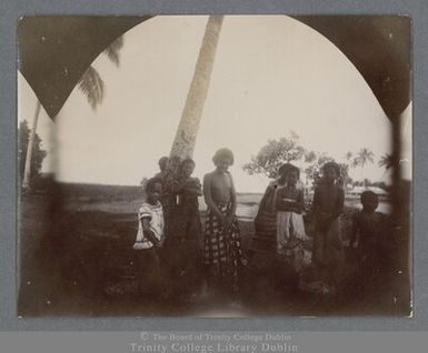 Photograph of a group of Samoan children under a palm tree in Apia, Samoa