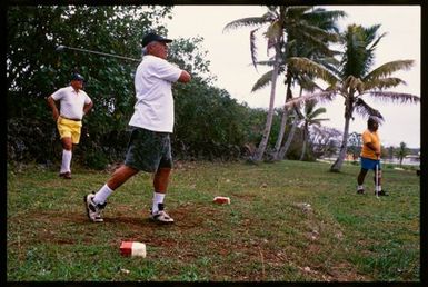 Men playing golf, Niue