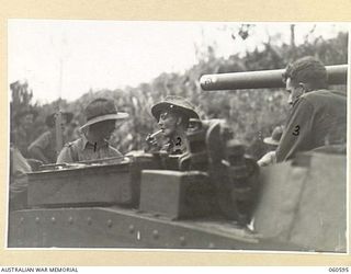 SATTELBERG AREA, NEW GUINEA. 1943-11-17. SX10307 CAPTAIN D. P. HILL. (1) AND LIEUTENANT GREGORY. (2) BOTH OF THE 2/48TH AUSTRALIAN INFANTRY BATTALION ENJOY A SMOKE BEFORE THE ASSAULT ON SATTELBERG