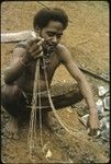 Man holding shell money