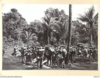 PALMALMAL, JACQUINOT BAY, NEW BRITAIN, 1945-08-13. HEADQUARTERS 5 DIVISION TROOPS WAITING FOR THEIR NAMES TO BE CALLED FOR CHECKING AND ALLOCATION OF EMBARKATION NUMBERS PRIOR TO THEIR RETURN TO ..