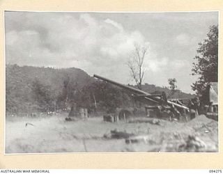 BOIKEN, NEW GUINEA, 1945-07-18. PERSONNEL OF 2/2 FIELD REGIMENT ROYAL AUSTRALIAN ARTILLERY, USING A 155MM M1 "LONG TOM" TO FIRE ON A JAPANESE POSITION 14,600 YARDS AWAY