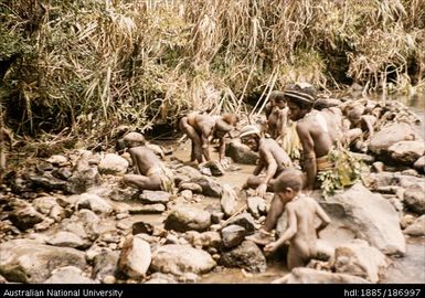 Men and boys damming