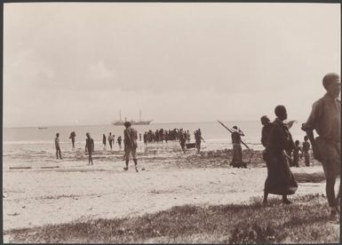 Missionaries in boat arriving on beach at Mota Lava, Southern Cross in distance, Banks Islands, 1906 / J.W. Beattie