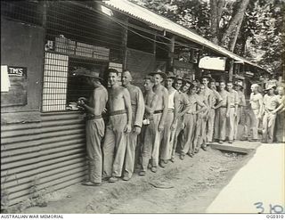 VIVIGANI, GOODENOUGH ISLAND, PAPUA. 1943-09-24. PAY PARADE DOES NOT MATTER MUCH AT REALLY ADVANCED BASES, FOR THERE IS LITTLE ON WHICH TO SPEND MONEY BUT MOST MEN OF NO. 7 MOBILE WORKS SQUADRON ..