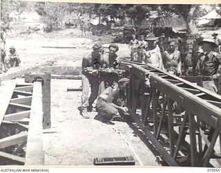 NAGADA, NEW GUINEA. 1944-09-11. SAPPERS OF THE 5TH FIELD COMPANY, JOINING SECTIONS OF A SMALL BOX GIRDER BRIDGE DURING THE CONSTRUCTION OF A NEW BRIDGE THE NAGADA RIVER ON THE MADANG-ALEXISHAFEN ..