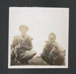 Woman and boy with puppies, Aiyura, Papua New Guinea, 1947