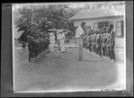 Men and children lined up for an assessment