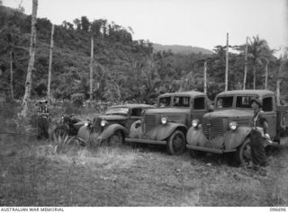 KAIRIRU ISLAND, NEW GUINEA. 1945-09-17. THE ENTIRE JAPANESE NAVAL TRANSPORT ON KAIRIRU ISLAND CONSISTING OF TWO 3-TON TRUCKS, ONE STAFF CAR (REAR-ADMIRAL SATO'S) AND ONE MOTOR CYCLE AND SIDECAR