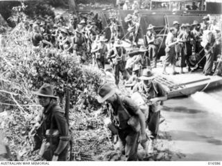 Huon Peninsula, New Guinea. 1943-09. Australian troops going ashore from landing craft in a drive to cut off retreating Japanese attempting to by-pass Allied held Saidor by an overland route