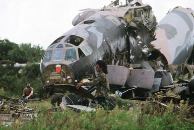 Workers take apart the nose of a B-52D Stratofortress bomber aircraft, one of three discarded in accordance with the SALT II treaty between the United States and the Soviet Union