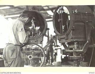 LAE, NEW GUINEA. 1944-03-24. NX190211 STAFF SERGEANT J. S. MUNDY REPAIRING BEACH LIGHTS IN THE ELECTRICAL WORKSHOP SECTION OF THE AUSTRALIAN FORTRESS WORKSHOP