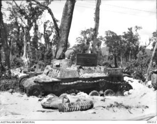 Cape Boram, Wewak area, New Guinea.  Personnel examining an armoured recovery variant of the medium type 97 Chi Ha tank, which was captured on the beach.  Army workshops, the tank regiments and the ..