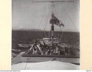 SUB-LIEUTENANT D.R. ROSS, GUNNERY OFFICER, ROYAL AUSTRALIAN NAVAL RESERVE (1), AND LIEUTENANT R.C. POCKLEY, CAPTAIN, ROYAL AUSTRALIAN NAVAL VOLUNTEER RESERVE (2), AT ACTION STATIONS ABOARD THE ..