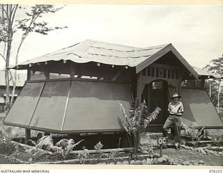 LAE, NEW GUINEA. 1944-09-28. VX104118 MAJOR R.C. UPSON, OFFICER COMMANDING 22ND WORKS COMPANY, ROYAL AUSTRALIAN ENGINEERS (1), STANDING OUTSIDE HIS QUARTERS